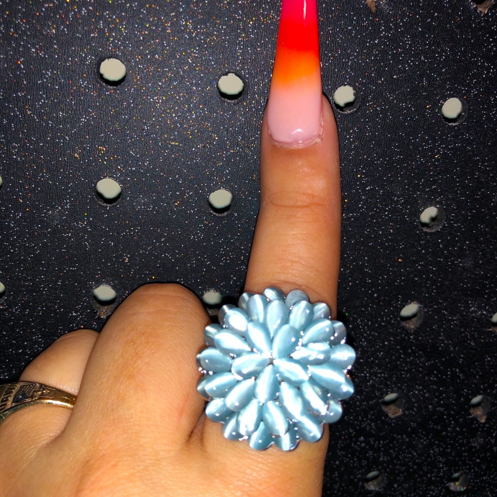 Silver flower ring with blue “cat-eye” stones
